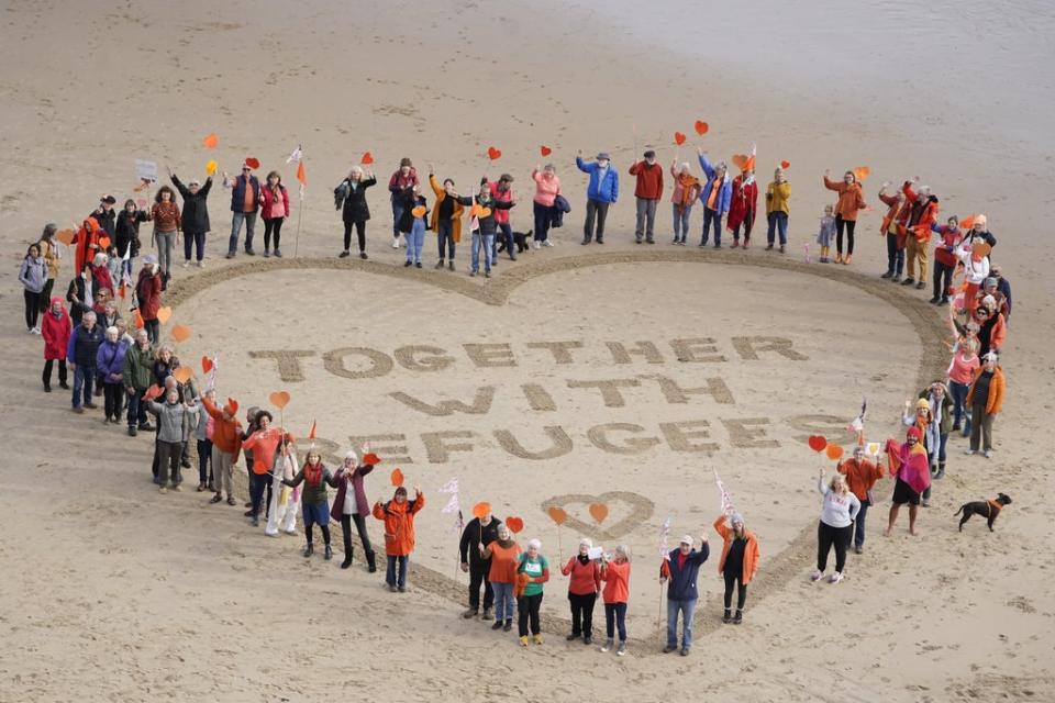 Demonstrators on King Edward’s Bay Beach in Tynemouth to show solidarity for refugees and to protest against the Nationality and Borders Bill which is currently going through parliament (Owen Humphreys/PA) (PA Wire)