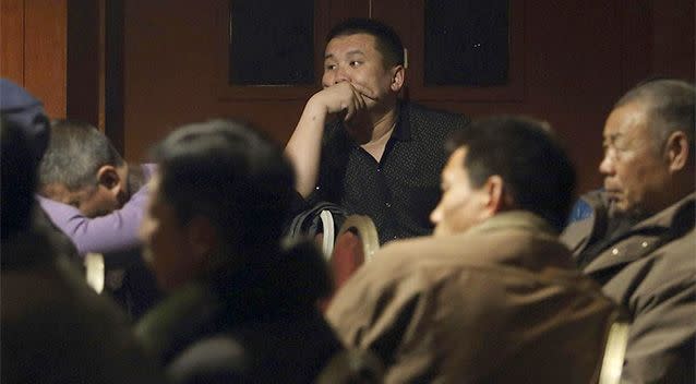 Relatives of passengers of Malaysia Airlines flight MH370 watch news on TV at a hotel in Beijing March 10, 2014. China urged Malaysia to step up the search for a Malaysia Airlines jetliner that went missing with 239 people on board, about two-thirds of them Chinese, and said it has sent security agents to help with an investigation into the misuse of passports. Photo: REUTERS/Chance Chan.