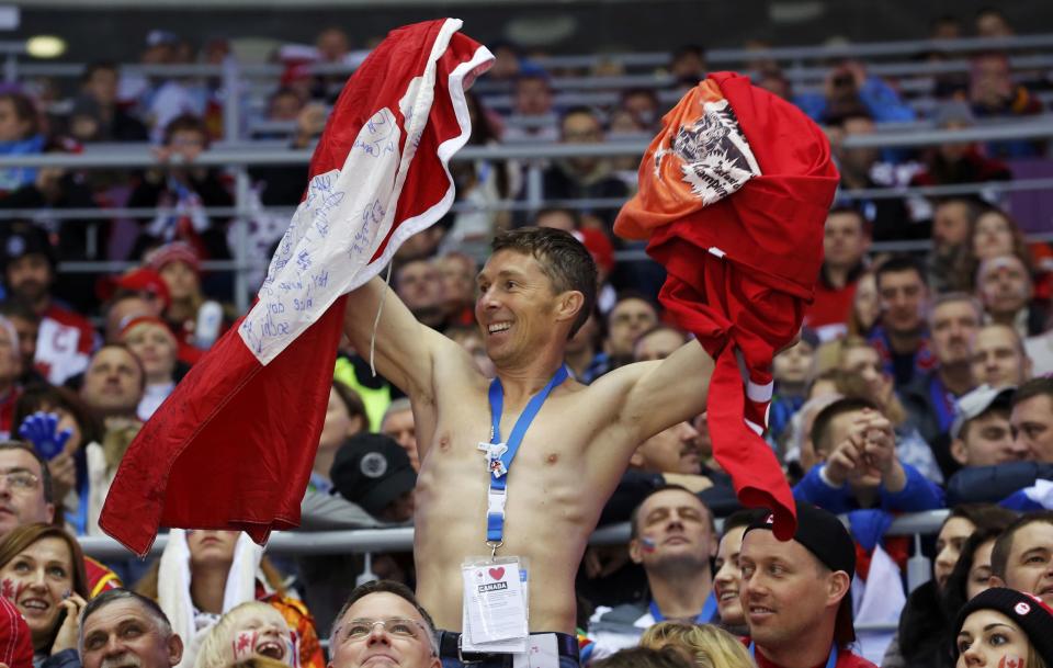 A fan cheers during the men's preliminary round ice hockey game between Canada and Finland at the Sochi 2014 Winter Olympic Games February 16, 2014. REUTERS/Mark Blinch (RUSSIA - Tags: OLYMPICS SPORT ICE HOCKEY)