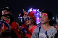 Supporters of Han Kuo-yu, presidential candidate for Taiwan's main opposition Kuomintang (KMT) party, sport signature red and blue