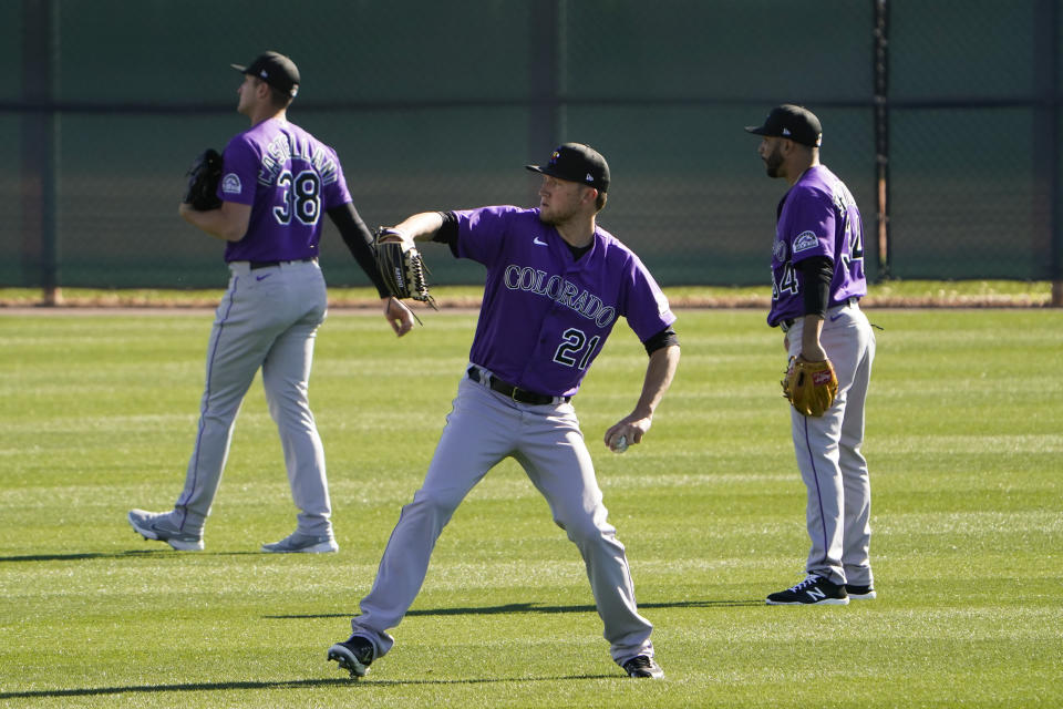 Colorado Rockies starting pitcher Kyle Freeland, center, throws during the team's spring training baseball workout in Scottsdale, Ariz., Wednesday, Feb. 24, 2021. (AP Photo/Jae C. Hong)