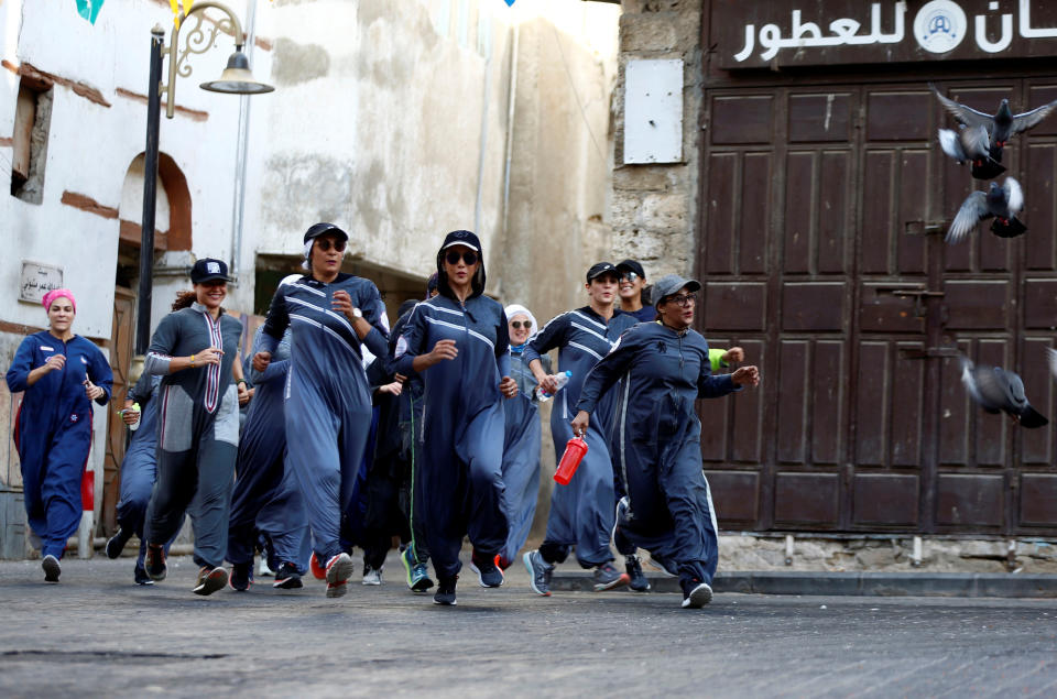 Women run during an event marking International Women's Day in Old Jeddah.