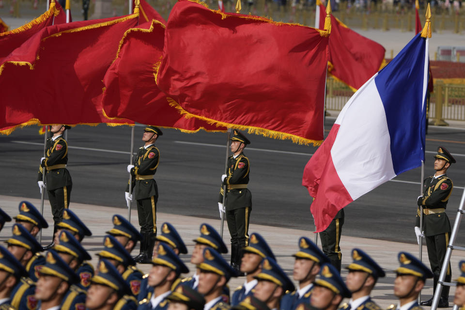 FILE - A Chinese honor guard holds a French national flag during a welcome ceremony for the French President Emmanuel Macron outside the Great Hall of the People in Beijing, on April 6, 2023. In the weeks since Chinese leader Xi Jinping won a third five-year term as president, setting him on course to remain in power for life, leaders and top diplomats from around the world have been beating a path to his door. None more-so than those from Europe. (AP Photo/Ng Han Guan, Pool, File)