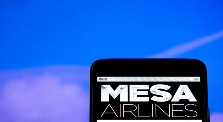 mesa airlines (MESA) logo on a mobile phone with clear sky in the background