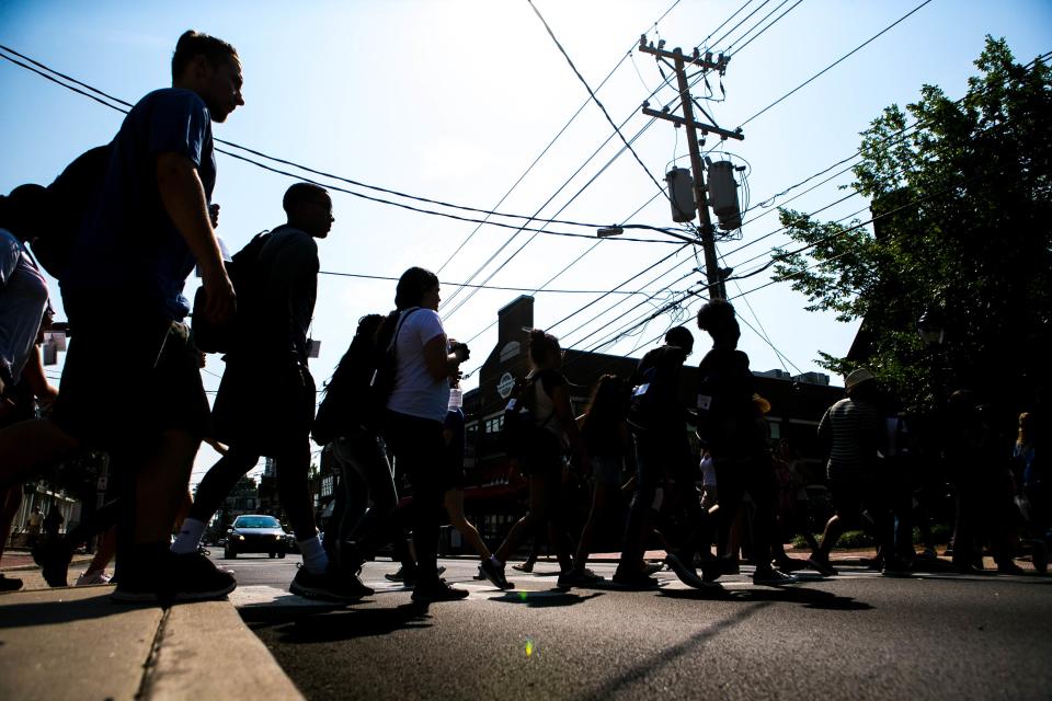 Pedestrians use a crosswalk at a traffic light on Main Street in Newark in 2018.