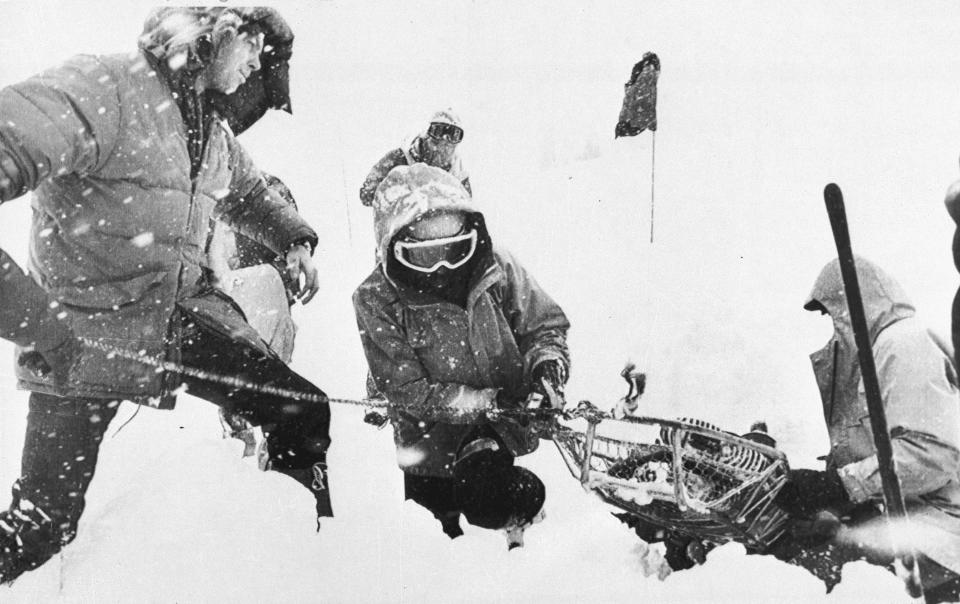 FILE - Rescue workers recover a body April 2, 1982, buried in the parking lot of the Alpine Meadows ski resort after an avalanche that killed seven people rolled through the area in the Sierra Nevada mountains near Palisades Tahoe, Calif. The Alpine avalanche on March 31, 1982, was the deadliest avalanche to sweep through a ski area. Since December 2022, a parade of a dozen atmospheric storms have dumped so much snow up and down the Sierra that several ski resorts around Lake Tahoe have had to shut down multiple times. The National Weather Service in Reno recently called it the "winter that just doesn't want to end." (Dick Gilmore/Sacramento Bee via AP, File)