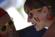 <p>A Belgium soccer fan wears wears facepaint in the Belgian colors as she watches a 2018 World Cup soccer match between Belgium and England on a giant screen in Jette, Belgium, Saturday, July 14, 2018. The match will determine third place. (AP Photo/Olivier Matthys) </p>