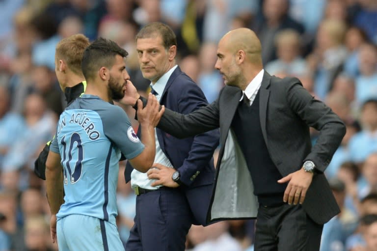 Manchester City's manager Pep Guardiola (R) greets Manchester City's striker Sergio Aguero after he was substituted during the English Premier League football match between Manchester City and West Ham United