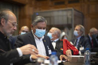 Bolivian Foreign Minister, Rogelio Mayta, second left, prepares for the verdict reading at the World Court in The Hague, Netherlands, Thursday, Dec. 1, 2022, where the UN's top court rules on a dispute about a river that crosses Chile's and Bolivia's border, in a case seen as important jurisprudence at a time when fresh water is becoming an increasingly coveted world resource. (AP Photo/Peter Dejong)