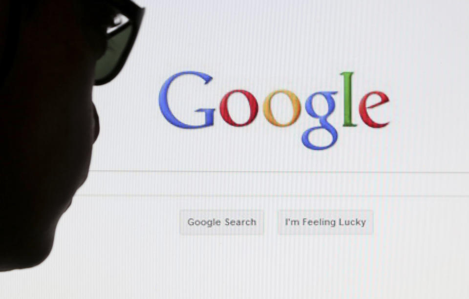 A computer user poses in front of a Google search page in this photo illustration taken in Brussels May 30, 2014. Google has taken the first steps to meet a European ruling that citizens can have objectionable links removed from Internet search results, a ruling that pleased privacy campaigners but raised fears that the right can be abused to hide negative information.   REUTERS/Francois Lenoir (BELGIUM - Tags: POLITICS SCIENCE TECHNOLOGY)