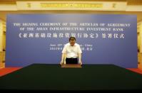 An officer from Chinese Finance Ministry prepares for a signing ceremony of articles of agreement of the Asian Infrastructure Investment Bank (AIIB), at the Great Hall of the People in Beijing, in this June 29, 2015 file photo. REUTERS/Jason Lee/Files