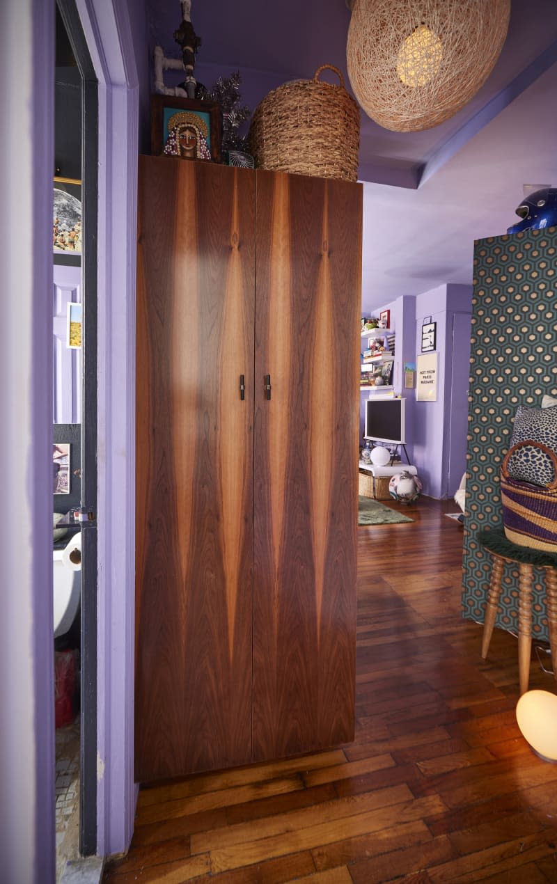 Wooden armoire in hallway of NYC apartment.