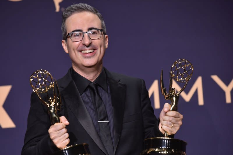 John Oliver holds two of the 26 Emmys "Last Week Tonight" has won. File Photo by Christine Chew/UPI