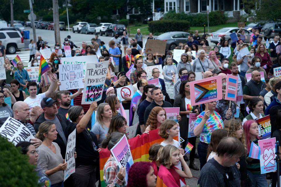 Protesters listen to speakers at the steps of the William Hall Library in Cranston on Monday evening.