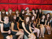 Reigning beauty queen, Miss May Hsu, joins the 2012 finalists in a group photo backstage. (Yahoo! Singapore/ Deborah Choo)