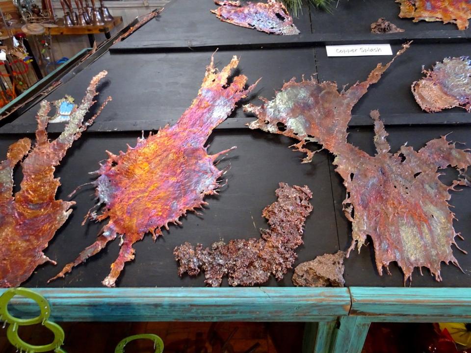 At a Splash of Copper in Globe, they create unique artworks by melting copper ore in a smelter, splashing it onto a steel plate, then polishing and heating it.