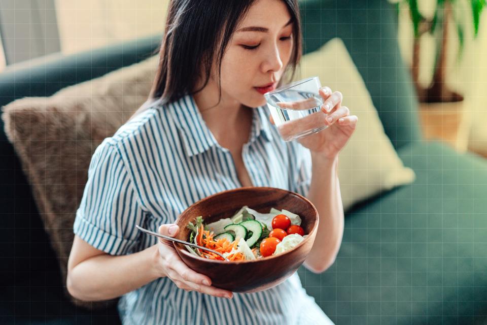 Woman Eating Vegetable Salad At Home