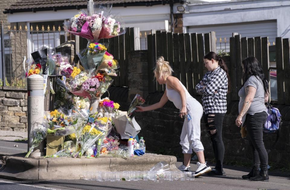 Floral tributes have been left at the scene of the attack, with candles and bottles of Yazoo milkshake placed near the spot where Khayri was stabbed (PA)