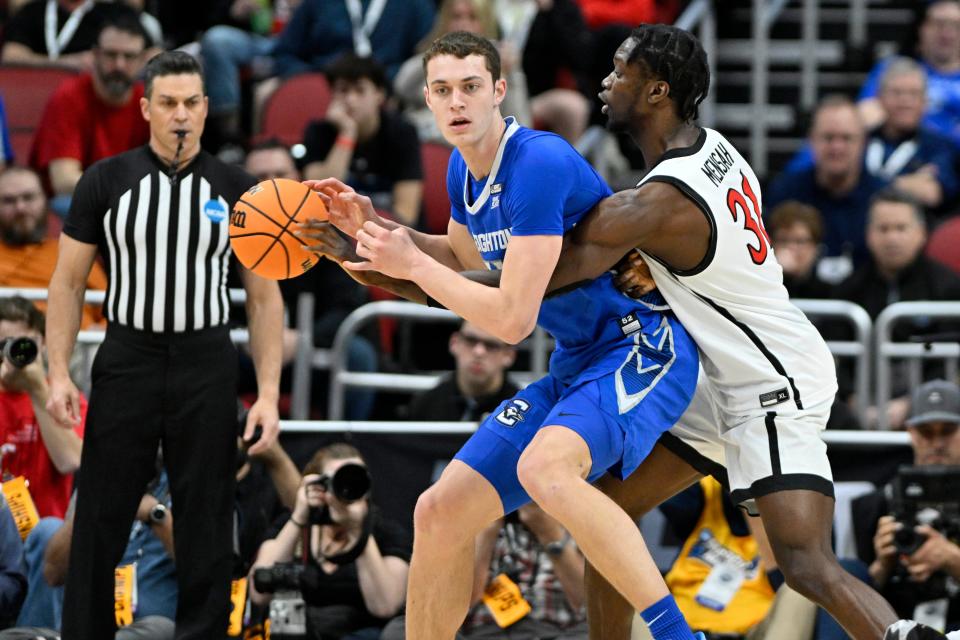 Creighton center Ryan Kalkbrenner (11) is defended by San Diego State forward Nathan Mensah during their NCAA men's tournament Elite Eight game at KFC YUM! Center.