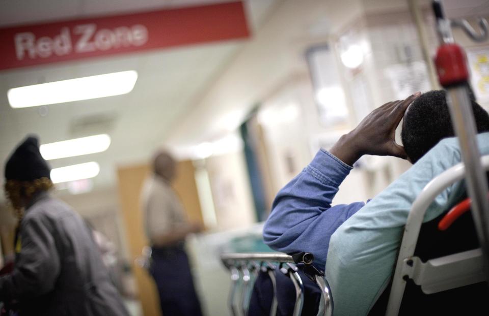 In this Feb. 18, 2011 photo, a patient waits in the halls of the trauma unit of the emergency room at Grady Hospital in Atlanta. A federal regulator says Atlanta's safety net hospital could lose its Medicare funding early next year if it doesn't take steps to correct problems found by investigators. But the hospital's CEO says those problems have already been fixed.   (AP Photo/David Goldman)