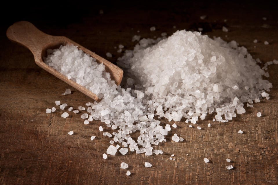 Original salt from ocean and typical spoon used for salt.