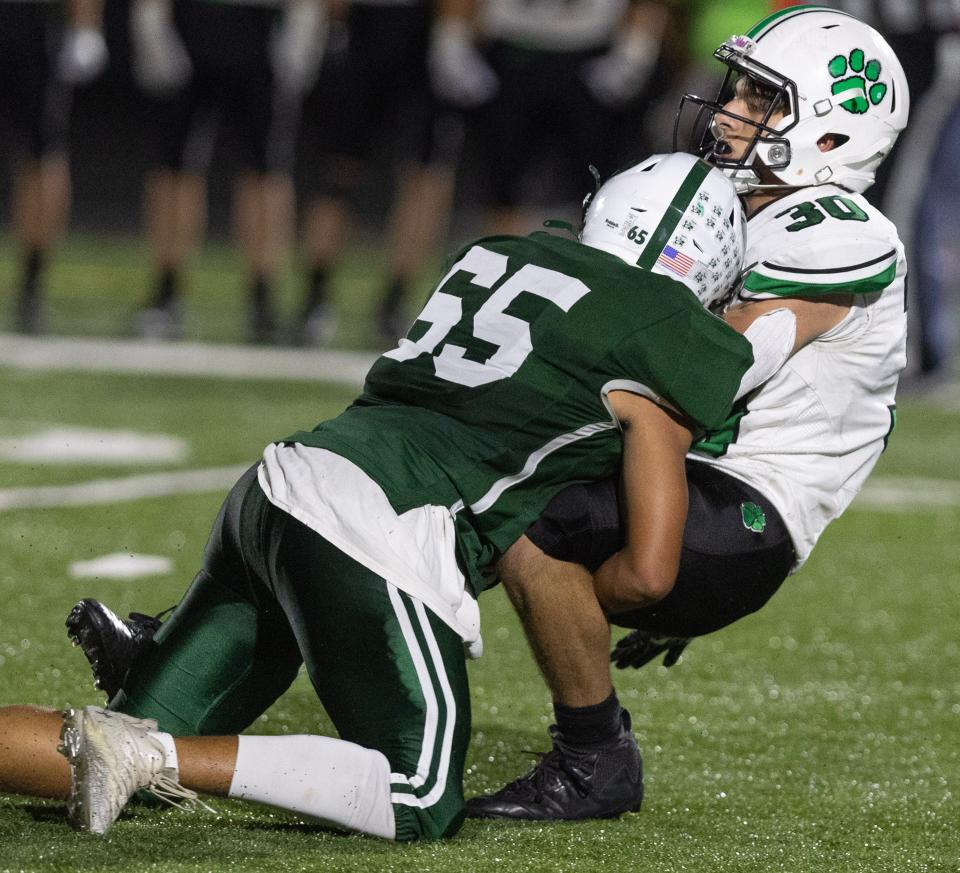 Central Catholic's Conner Thomas brings down Mogadore's Cole Reese in the second half, Friday Sept. 29, 2023.
