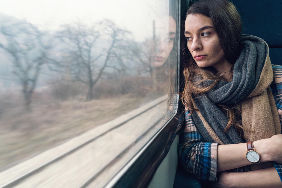On the train home, after their romantic weekend, Mary* discovered the truth about her boyfriend's feelings. Posed by model. (Getty Images)
