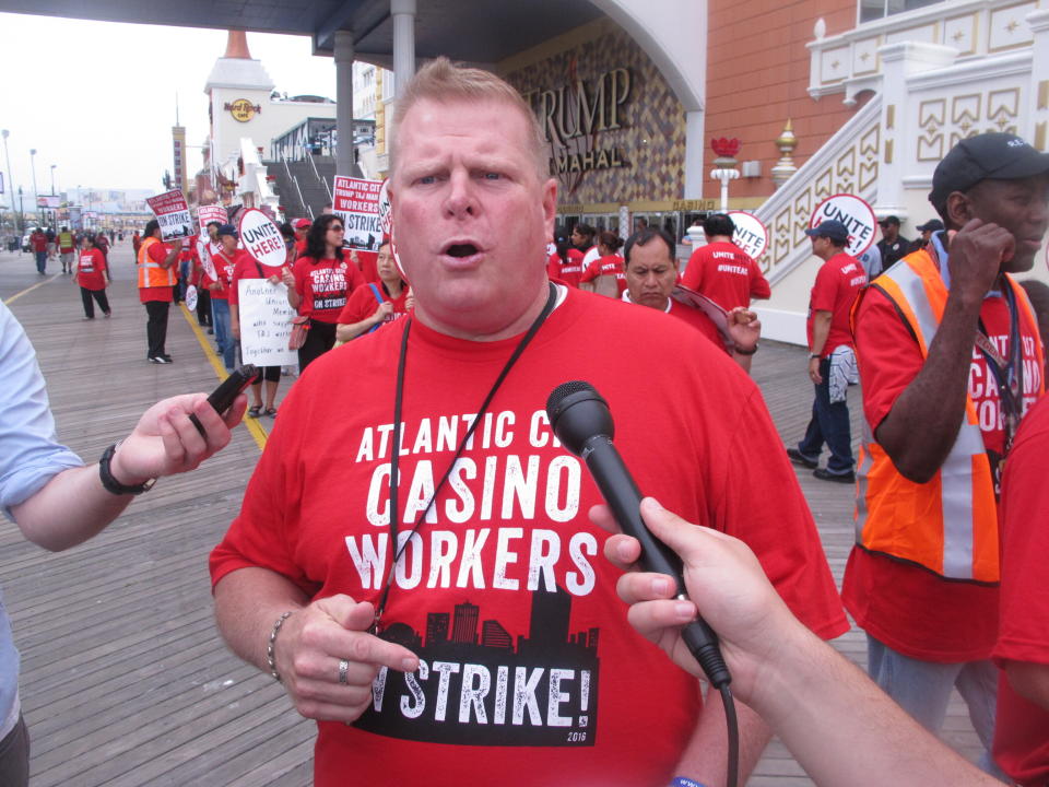 FILE: In this July 1, 2016 file photo, Bob McDevitt, left, president of Local 54 of the Unite Here casino workers union, speaks to reporters outside the Trump Taj Mahal casino in Atlantic City N.J. hours after the union went on strike against the casino. McDevitt is one of the leaders of an effort to change Atlantic City's form of government by eliminating an elected mayor in favor of an appointed city manager, a change that will go before voters on May 12, 2020. (AP Photo/Wayne Parry, file)