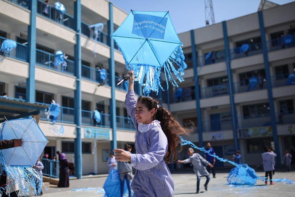 <p>Palestinian children fly UNRWA-logo kites outside their classrooms at a Palestine Refugee school to protest cut funding for UNRWA in Gaza City, Gaza on March 12, 2018.</p>