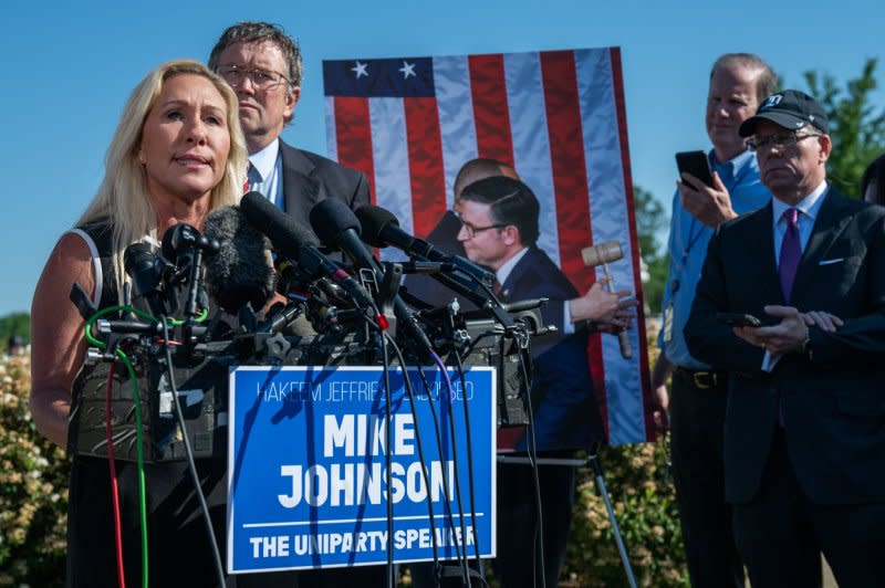 With U.S. Rep. Thomas Massie, R-Ky., behind her, U.S. Rep. Marjorie Taylor Greene, R-Ga., speaks at a press conference at the U.S. Capitol in Washington, D.C., on Wednesday. Greene announced that she would be moving forward with her motion to vacate Speaker of the House Mike Johnson, R-La., next week. Photo by Annabelle Gordon/UPI