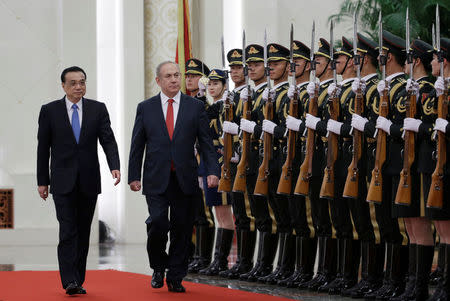 Israeli Prime Minister Benjamin Netanyahu and China's Premier Li Keqiang inspect honour guards during a welcoming ceremony at the Great Hall of the People in Beijing, China March 20, 2017. REUTERS/Jason Lee