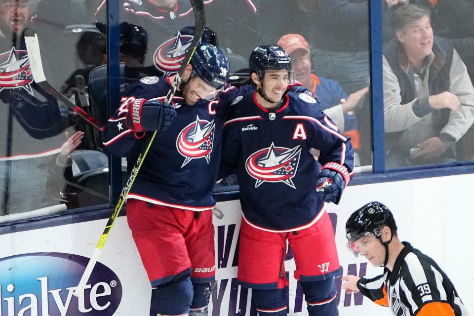 Mar 24, 2023; Columbus, Ohio, USA;  Columbus Blue Jackets center Boone Jenner (38) celebrates scoring the game-winning goal with left wing Johnny Gaudreau (13) during overtime of the NHL hockey game against the New York Islanders at Nationwide Arena. The Blue Jackets won 5-4. Mandatory Credit: Adam Cairns-The Columbus Dispatch