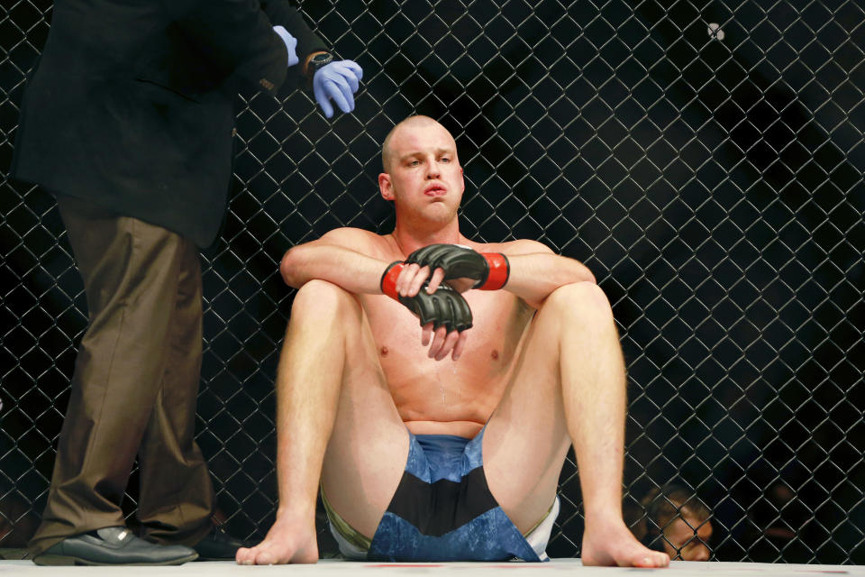 Dec 7, 2019; Washington, DC, USA; Stefan Struve (red gloves) reacts after taking a low kick by Ben Rothwell (blue gloves) during UFC Fight Night at Capital One Arena. Mandatory Credit: Amber Searls-USA TODAY Sports
