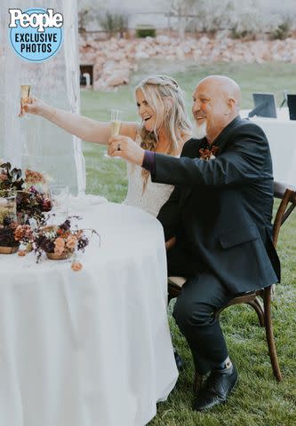 <p>Dani Sork Photo</p> Christine Brown and David Woolley raise their glasses at their wedding.