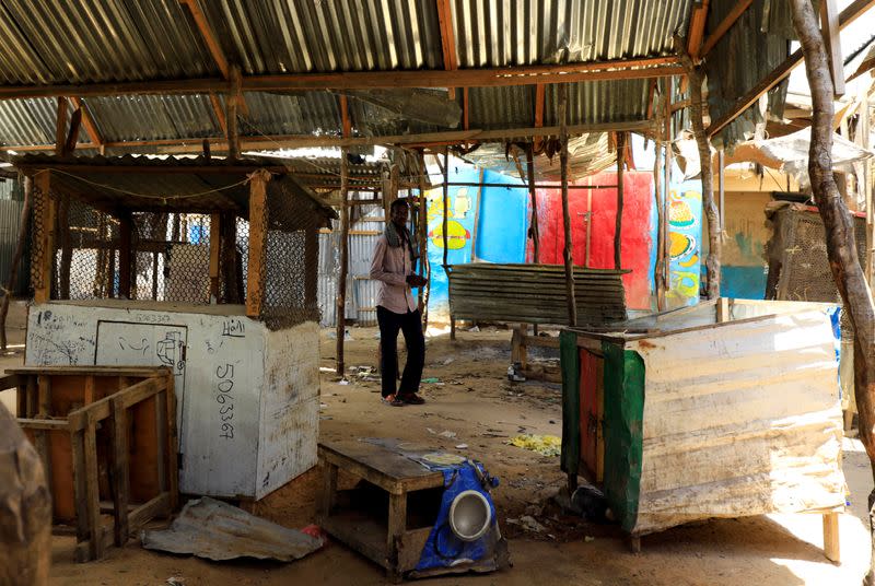 A Somali man walks at an abandoned khat stimulant market closed amid concerns about the spread of coronavirus disease (COVID-19), in Mogadishu