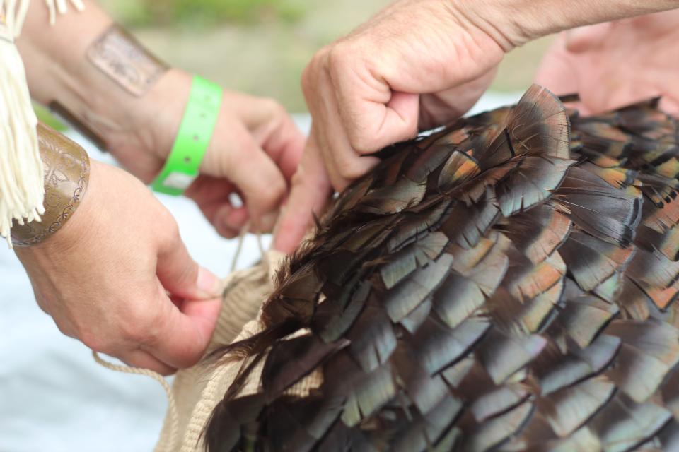 Julia Marden, a member of the Wampanoag Tribe of Gay Head (Aquinnah) used an ancient twining method to create a turkey feather mantle, which she revealed during the Aquinnah Wampanoag powwow Sunday.