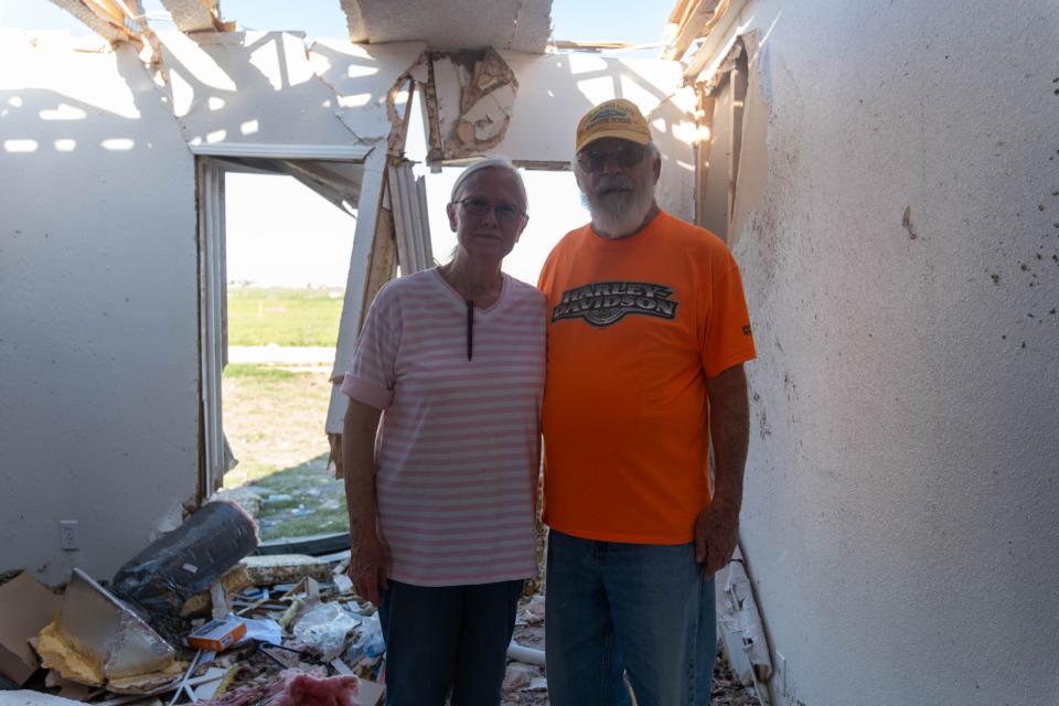 Lynn and Peggy Pattison stand in their damaged living room Monday afternoon in Perryton.