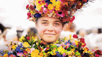 A woman in a floral crown smiles