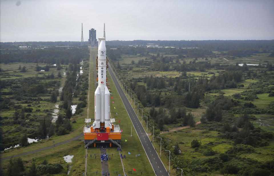 In this Nov. 17, 2020, photo released by China's Xinhua News Agency, a Long March-5 rocket is moved at the Wenchang Space Launch Site in Wenchang in southern China's Hainan Province. Chinese technicians were making final preparations Monday, Nov. 23, 2020, to launch a Long March-5 rocket carrying a mission to bring back material from the lunar surface in a potentially major advance for the country's space program. (Guo Cheng/Xinhua via AP)