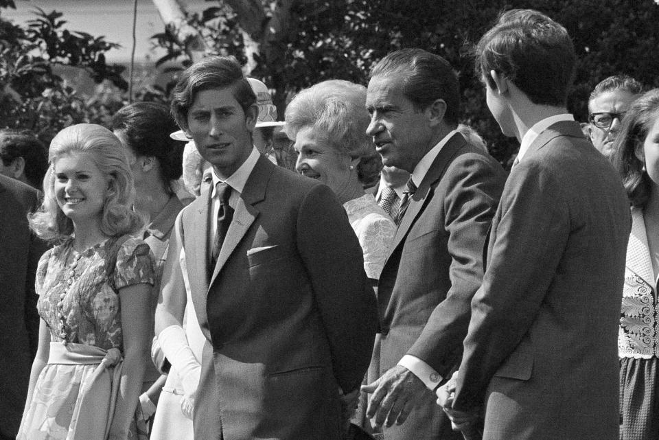 FILE - Britain's Prince Charles walks with first lady Pat Nixon, President Richard Nixon and his daughter Tricia Nixon on the White House lawn in Washington, July 16, 1970. (AP Photo, File)