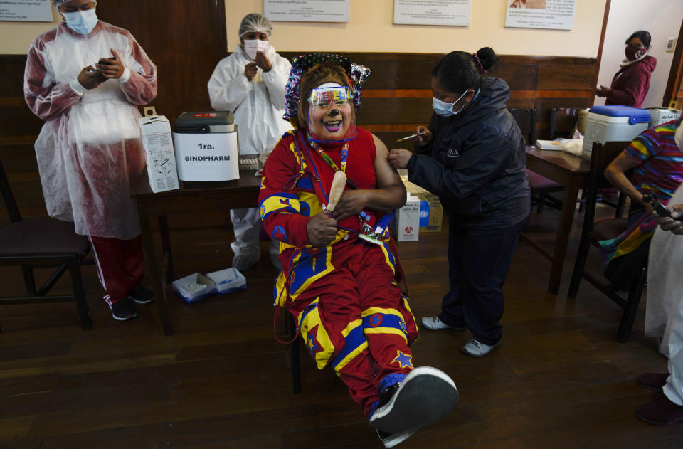 A clown gets a shot of the Sinopharm COVID-19 vaccine during a vaccination campaign targeting people between ages 18 and 30 at the public University San Andres in La Paz, Bolivia, Monday, July 5, 2021. (AP Photo/Juan Karita)