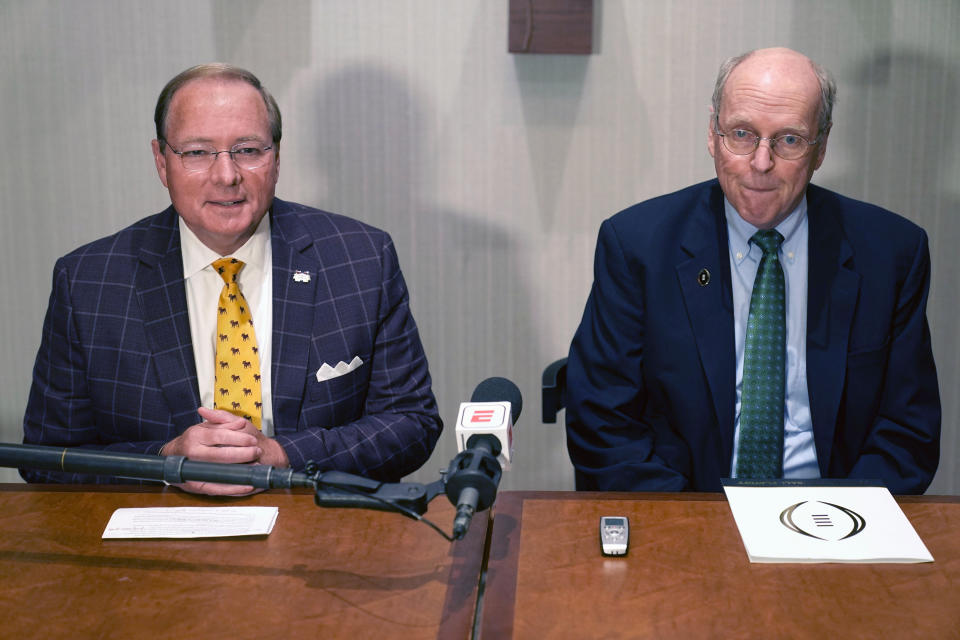 College Football Playoff Executive Director Bill Hancock, right, and Mark Keenum, Mississippi State president and chairman of the CFP presidents group listen to a reporter's question Tuesday, June 22, 2021, in Grapevine, Texas. The CFP met to discuss a proposed plan to expand the postseason format from four to 12 teams. (AP Photo/LM Otero)