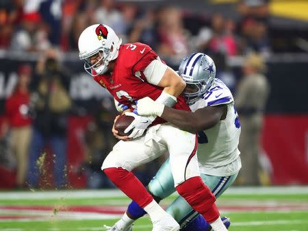 Sep 25, 2017; Glendale, AZ, USA; Arizona Cardinals quarterback Carson Palmer (3) is sacked by Dallas Cowboys defensive end DeMarcus Lawrence (90) in the second half at University of Phoenix Stadium. Mandatory Credit: Mark J. Rebilas-USA TODAY Sports