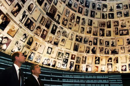 FILE PHOTO: Britain's Prince Edward (L) looks up at pictures of Jews killed in the Holocaust during a visit to the Hall of Names at Yad Vashem Memorial in Jerusalem September 7, 2007. REUTERS/Jim Holander/Pool/File Photo