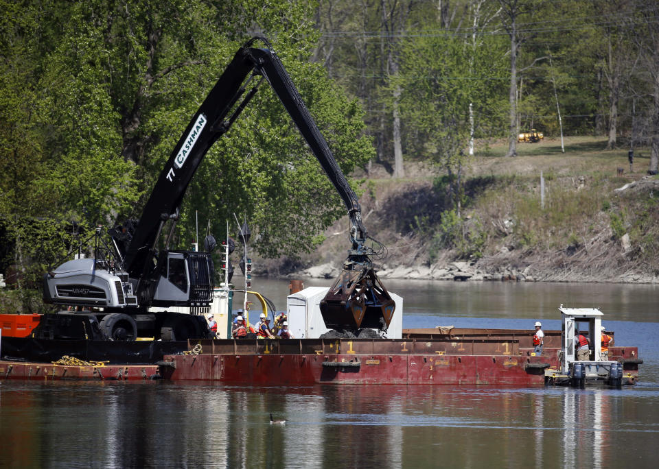 FILE- In this May 7, 2015 file photo, crews perform dredging work along the upper Hudson River in Waterford, N.Y. New York officials who are pushing for additional cleanup of the Hudson River followed through Wednesday, Aug. 21, 2019 on their promise of a lawsuit against the U.S. Environmental Protection Agency. The federal lawsuit seeks to overturn the EPA's decision in April not to compel General Electric to restart dredging for polychlorinated biphenyls from the upper river. Agency officials had said more time and testing are needed to fully assess the $1.7 billion Superfund cleanup. (AP Photo/Mike Groll, File)