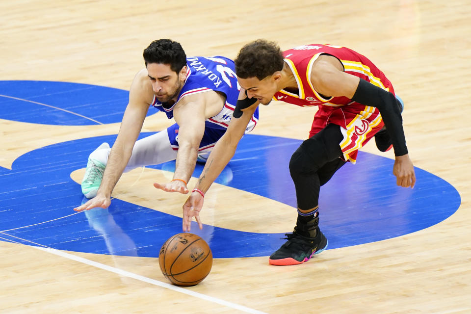 Atlanta Hawks' Trae Young, right, and Philadelphia 76ers' Furkan Korkmaz chase down a loose ball during the second half of Game 5 in a second-round NBA basketball playoff series, Wednesday, June 16, 2021, in Philadelphia. (AP Photo/Matt Slocum)