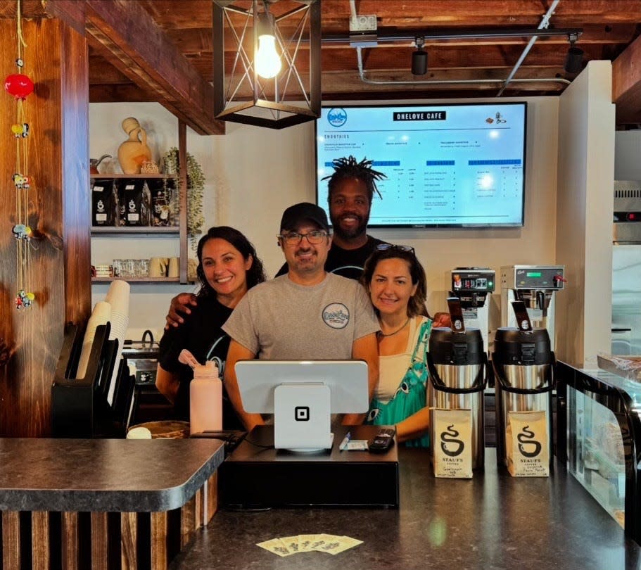 OneLove Cafe and Bike Shop’s four co-owners, from left, Fulya Doslovich, Oz Turkmen, Michael Brown and Asu Turkmen, during the shop's soft opening on July 4. The combination cafe and bike shop is located at 415 S. Main St., Granville.