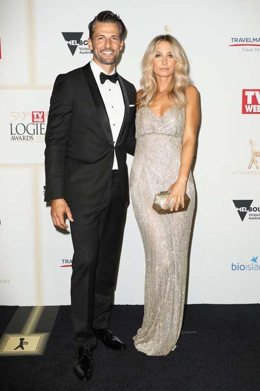 <p>Anna Heinrich channeled her inner gold logie in this glistening column gown by Steven Khalil. She matched it with Stuart Weitzman heels and a simple, gold Mimco clutch. Tim Robards looked as dashing as ever as he suited up in this Hugo Boss tux complete with a pocket square and a black dicky bow.</p>