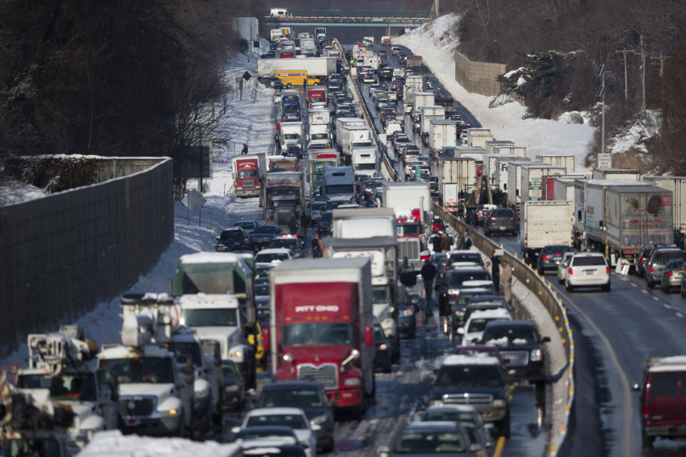 Vehicles are piled up in an accident Friday, Feb. 14, 2014, in Bensalem, Pa. Traffic accidents involving multiple tractor trailers and dozens of cars have completely blocked one side of the Pennsylvania Turnpike outside Philadelphia and caused some injuries. (AP Photo/Matt Rourke)