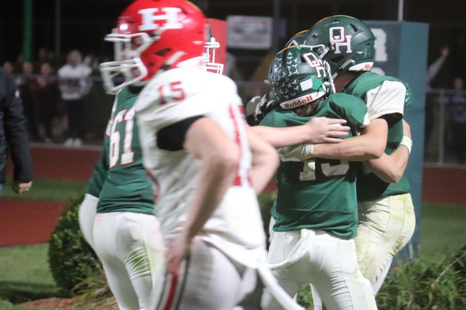 Oak Harbor's Carson Ridener is surrounded by teammates after his conversion reception.